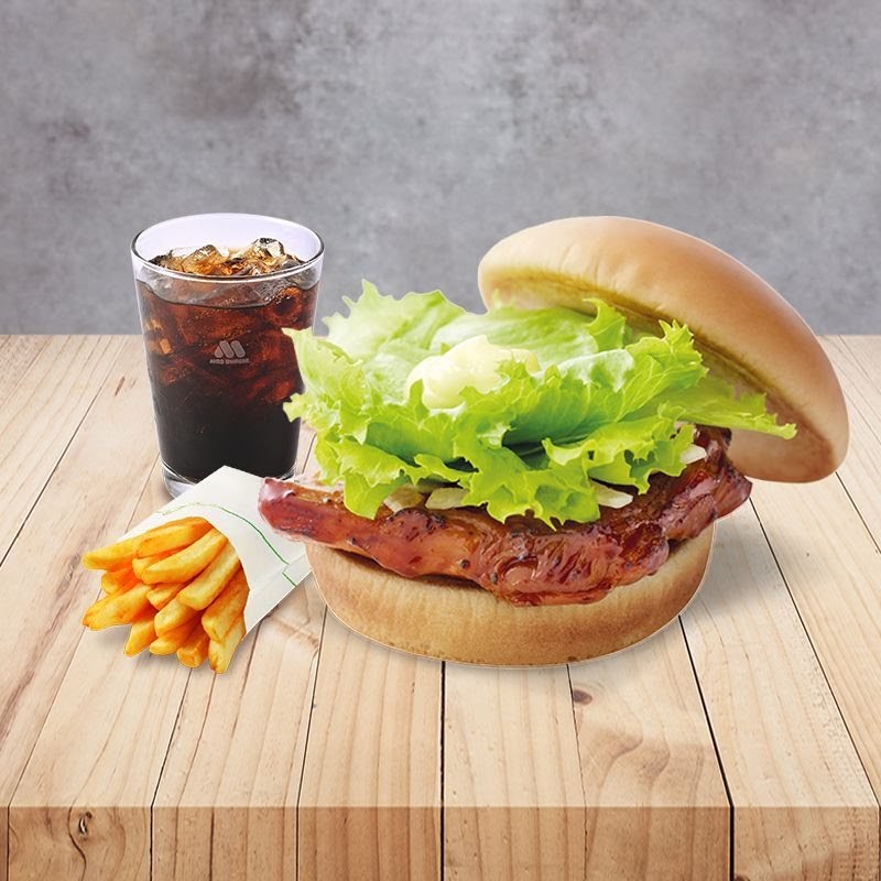 A delicious MOS Burger meal featuring a chicken burger, crispy fries, and a refreshing cola drink.