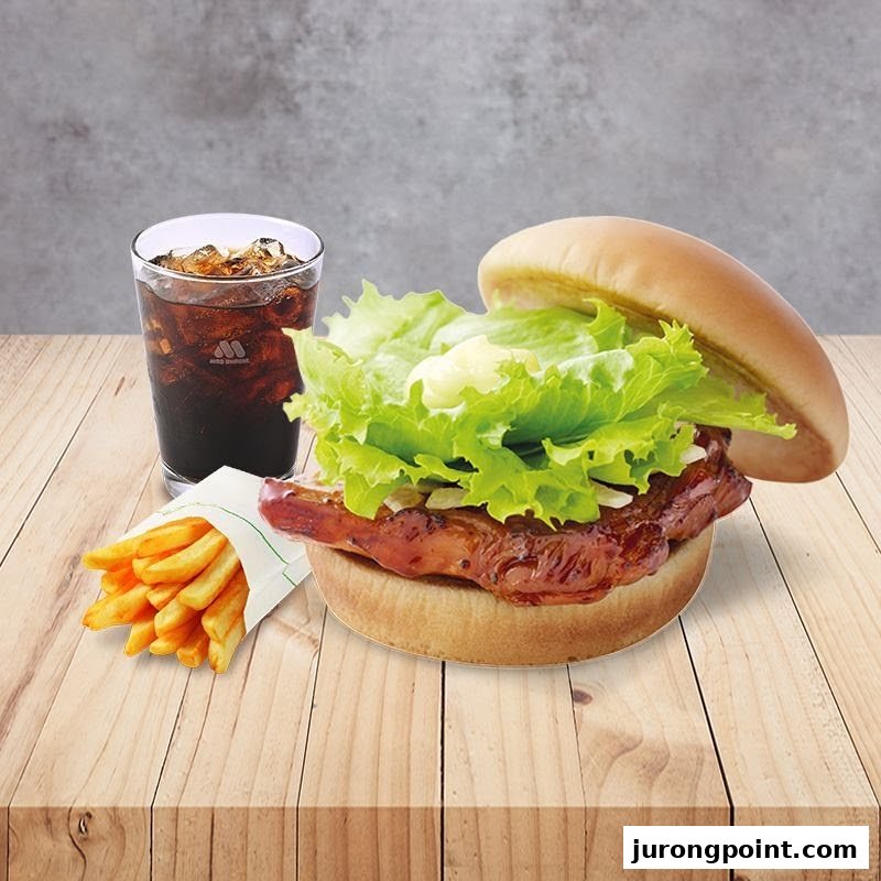 A delicious MOS Burger meal featuring a chicken burger, crispy fries, and a refreshing cola drink.