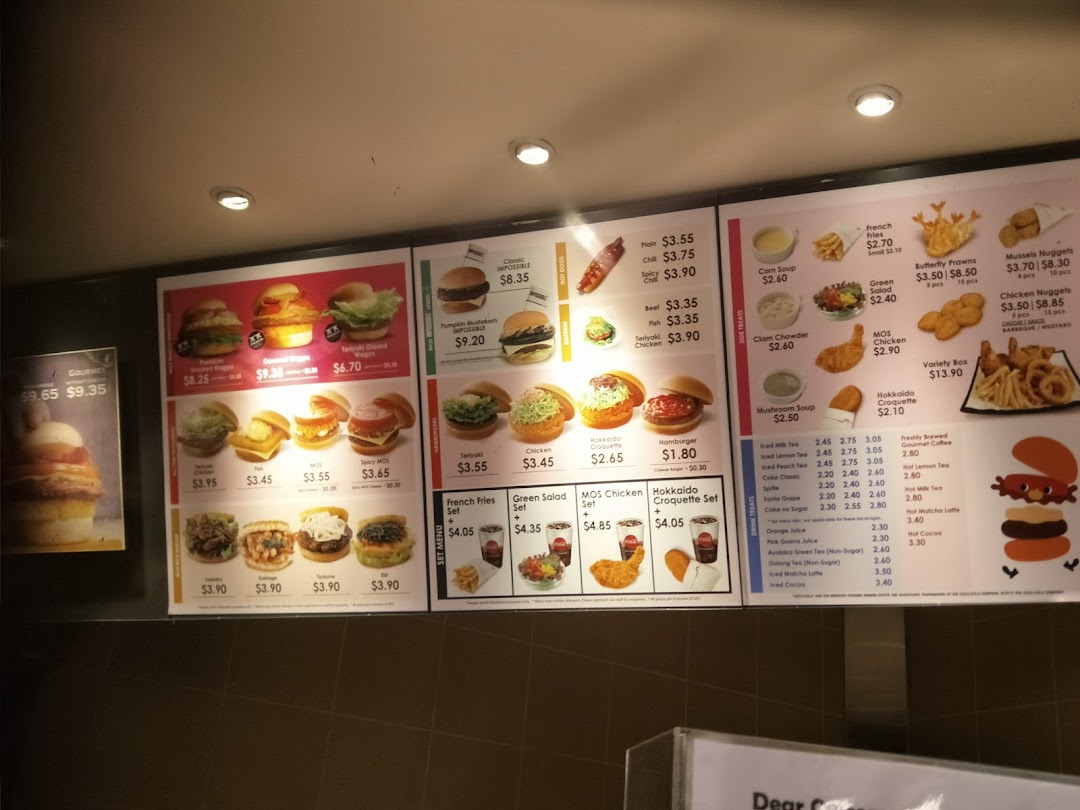A brightly lit digital menu board displaying a variety of burgers, sides, and drinks at MOS Burger.