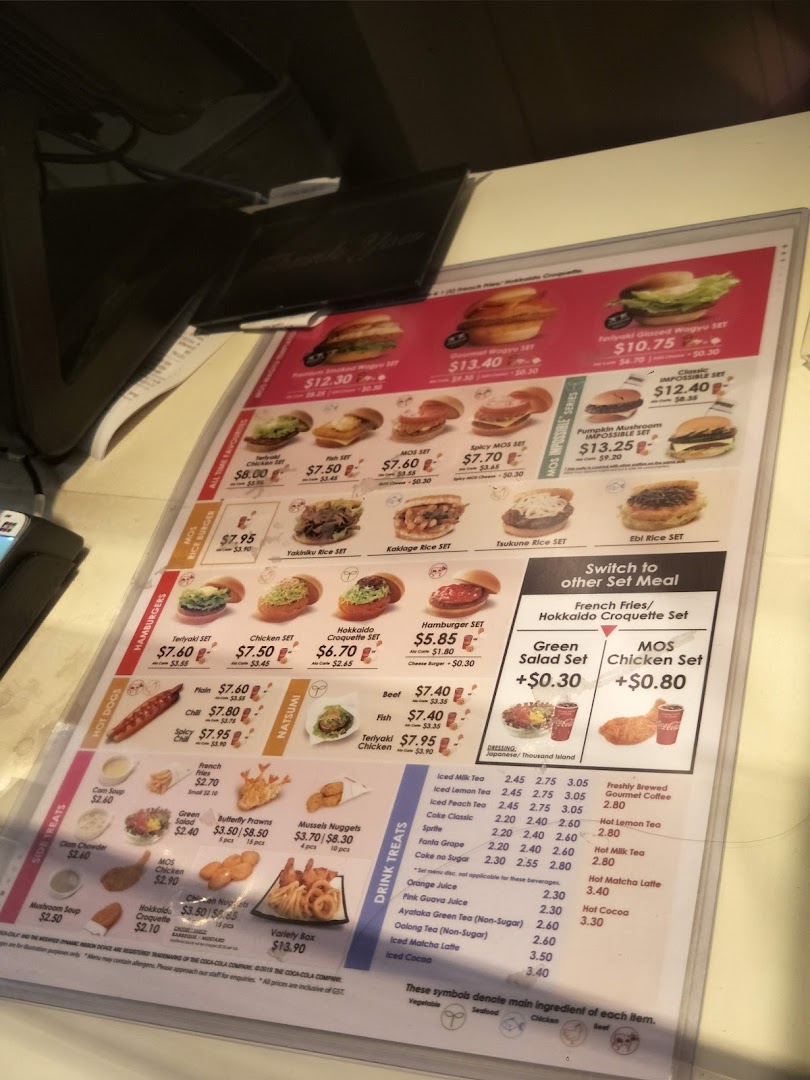 A detailed menu display for MOS Burger, showcasing various burgers, sets, sides, and drinks with prices.
