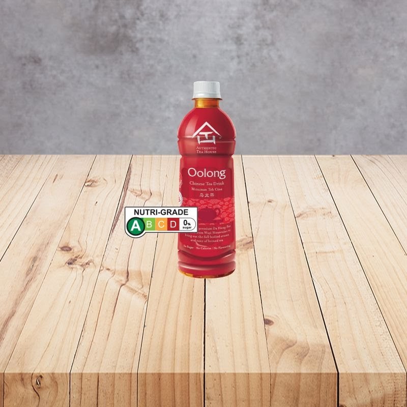 A bottle of Authentic Tea House Oolong Chinese Tea Drink with a Nutri-Grade label on a wooden table.
