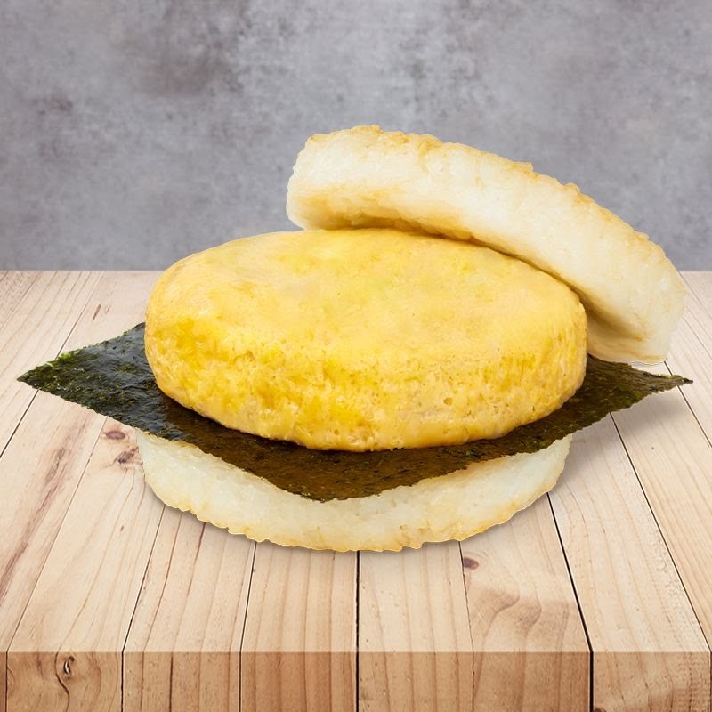 A close-up of a MOS Burger rice burger with an egg patty, seaweed, and rice buns.
