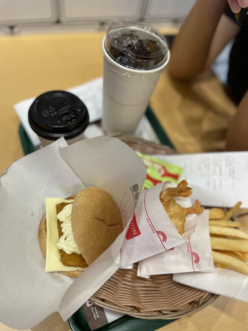 A MOS Burger meal with a fish burger, fried shrimp, fries, and drinks on a tray.
