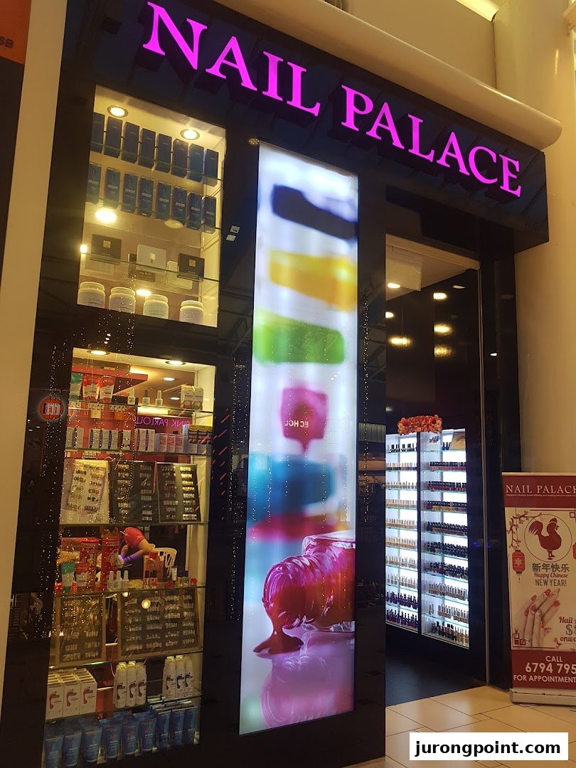 The brightly lit exterior of Nail Palace, showcasing its entrance, display windows, and vibrant signage.