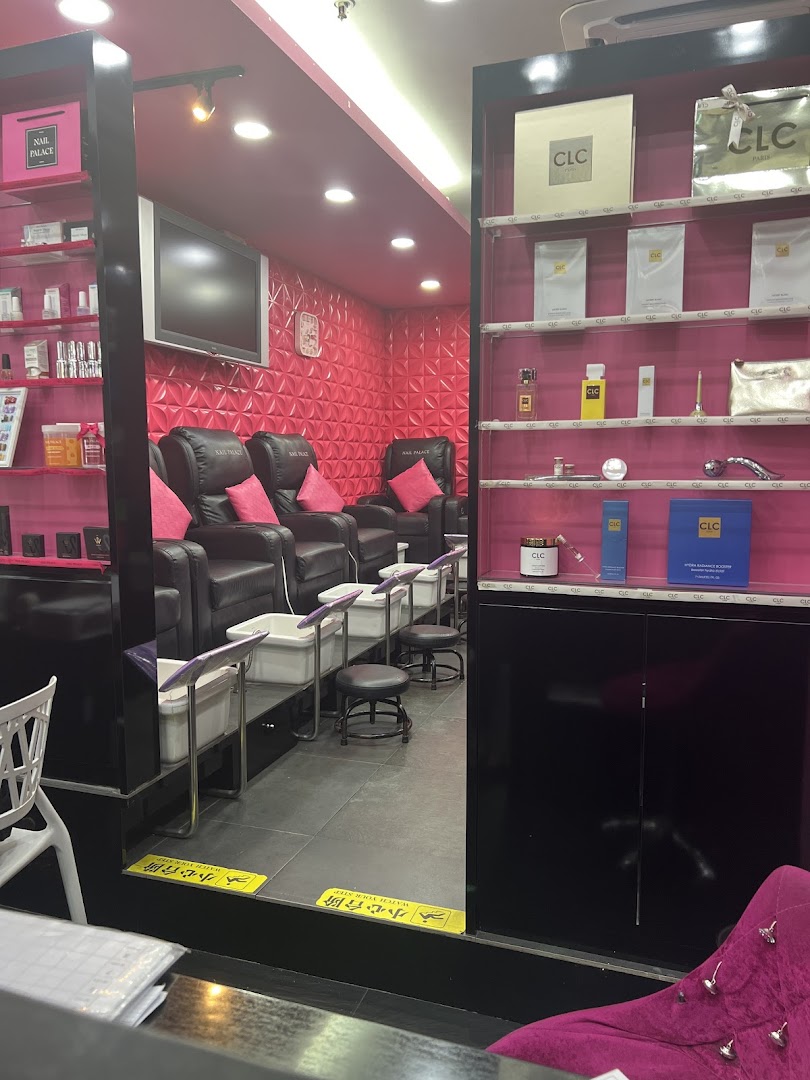 Interior view of Nail Palace showing comfortable pedicure chairs and foot baths in a vibrant pink setting.