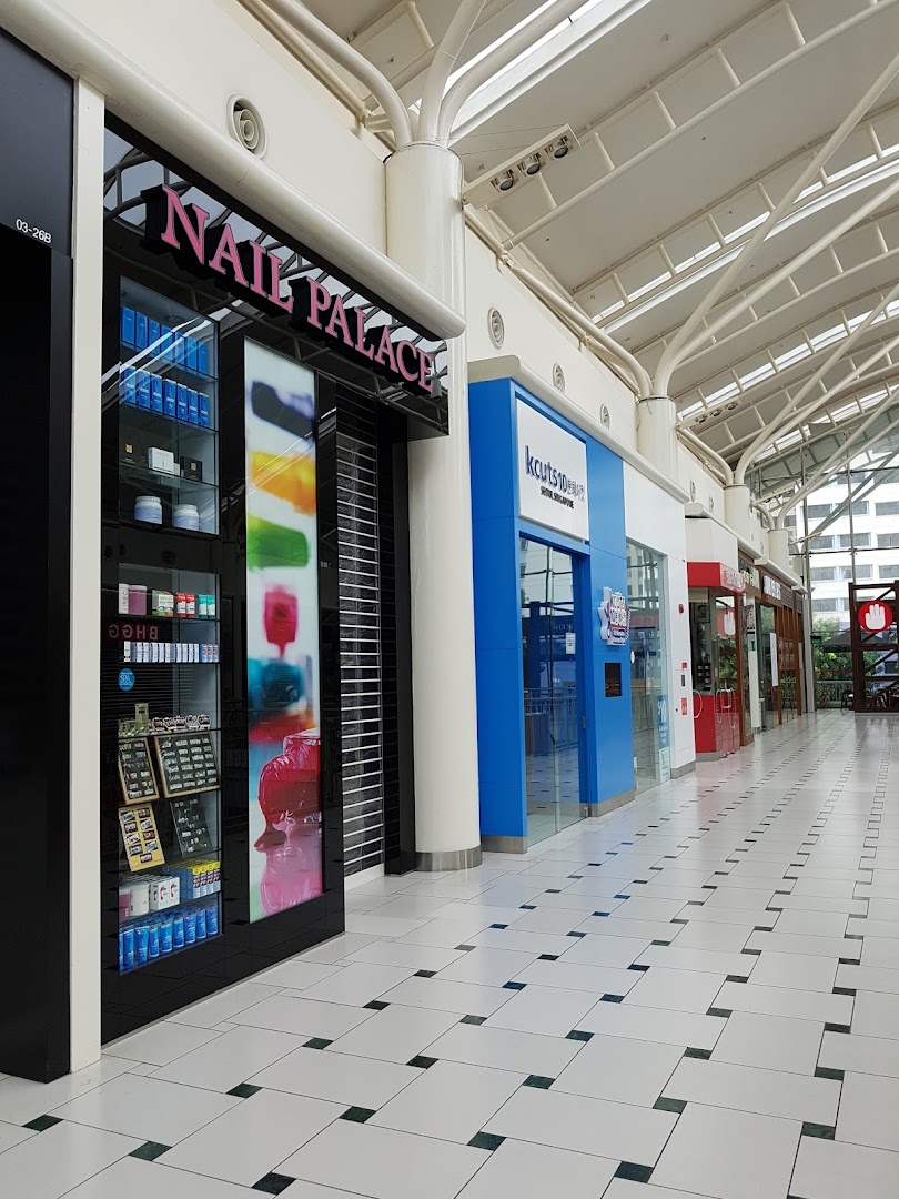 Exterior view of Nail Palace shop front with a display cabinet and closed shutters in a mall corridor.