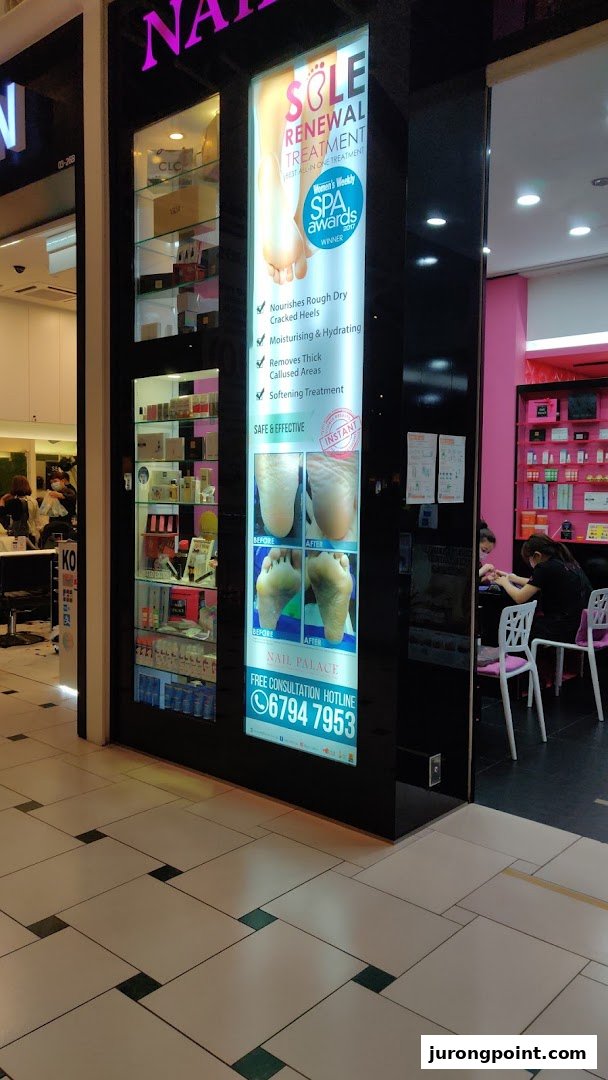 The shop front of Nail Palace features a bright display advertising 'Sole Renewal Treatment' and shows staff attending to customers inside.