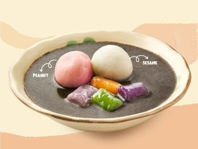 A bowl of traditional Taiwanese dessert featuring peanut and sesame tangyuan in black sesame soup.