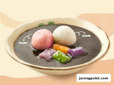 A bowl of traditional Taiwanese dessert featuring peanut and sesame tangyuan in black sesame soup.