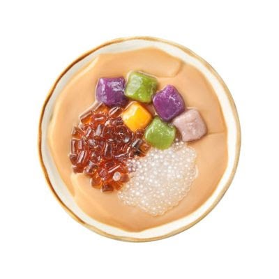 A top-down view of a bowl of Taiwanese dessert with colorful taro balls, grass jelly, and sago.
