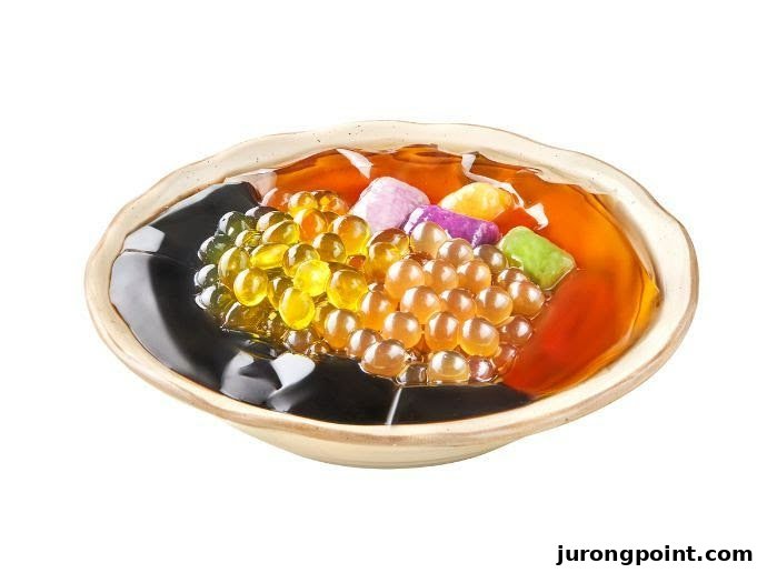 A vibrant bowl of Taiwanese dessert featuring grass jelly, konjac jelly, and popping boba.