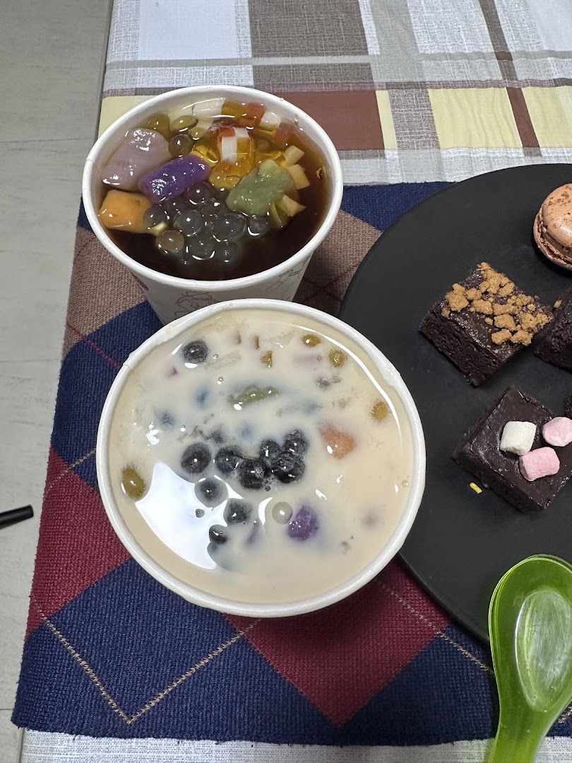 Two refreshing Taiwanese desserts with various toppings and a plate of delightful pastries.