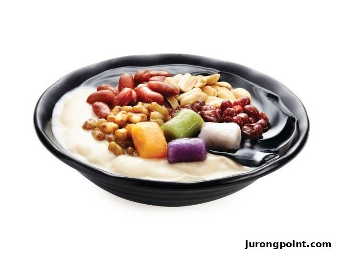 A vibrant bowl of Taiwanese dessert featuring taro balls, beans, and peanuts on a white background.