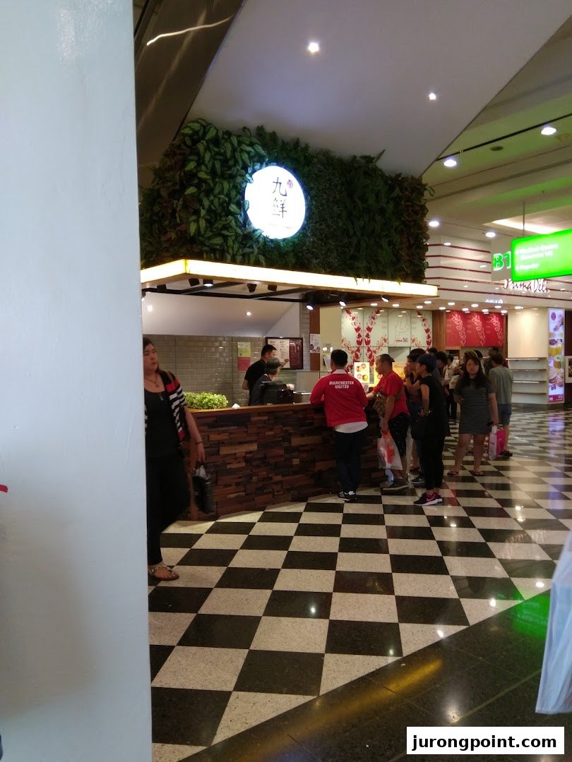 The Nine Fresh Desserts Taiwan shop front with its distinctive green wall and customers queuing.
