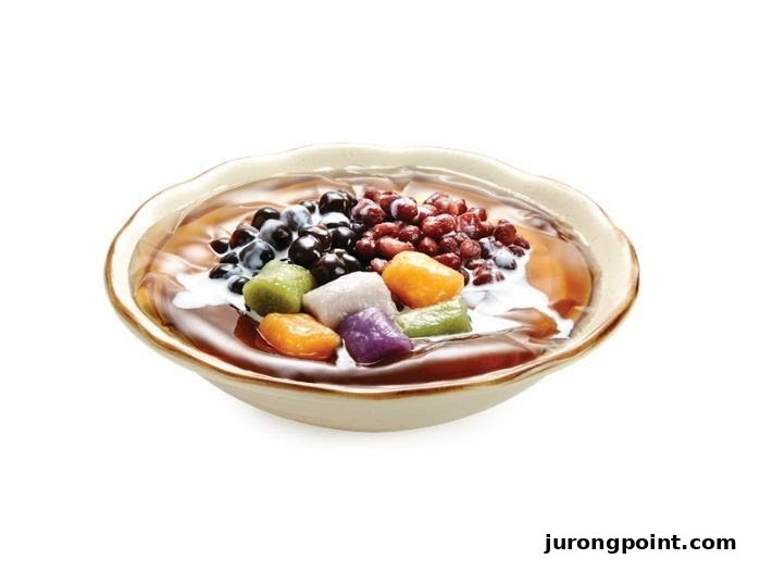 A vibrant bowl of Taiwanese dessert featuring taro balls, red beans, and grass jelly.