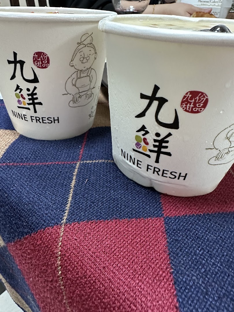 Two Nine Fresh dessert cups with condensation, resting on a plaid surface.