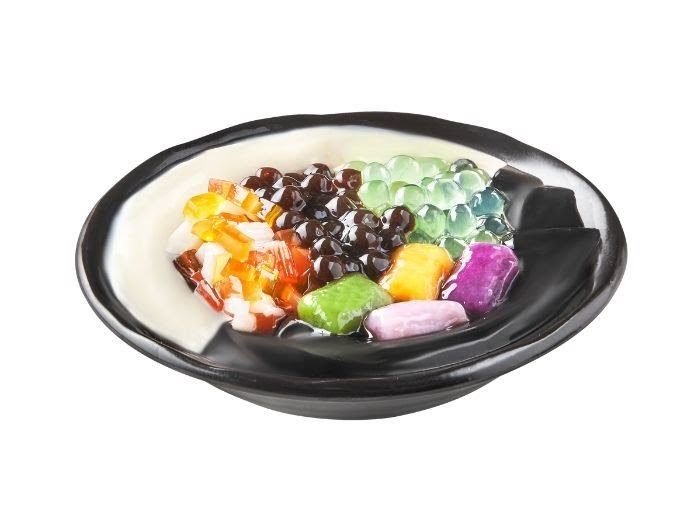 A vibrant bowl of Taiwanese dessert featuring various toppings like pearls, jellies, and taro balls.