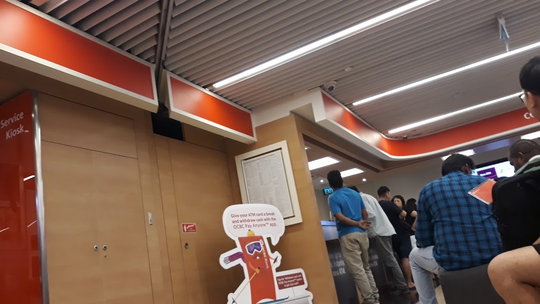 Interior view of OCBC Bank at Jurong Point, showing customers and a service kiosk.