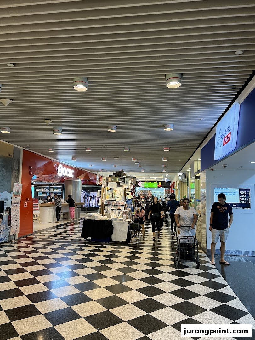 View of OCBC Bank entrance and a mall corridor with a checkered floor at Jurong Point.