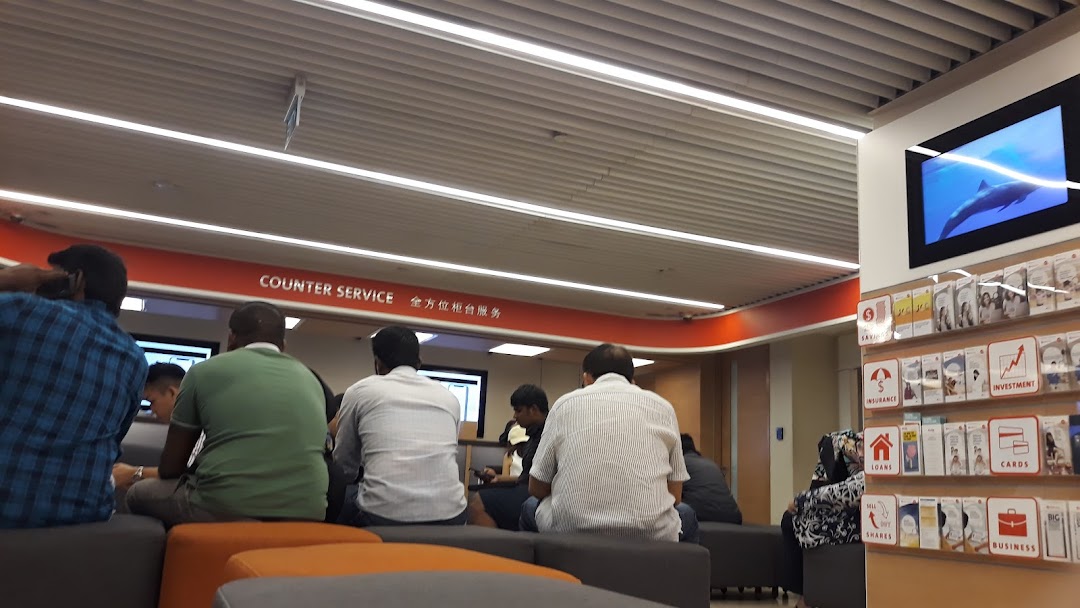 Customers waiting in the OCBC Bank Jurong Point branch, with a 'Counter Service' sign visible.