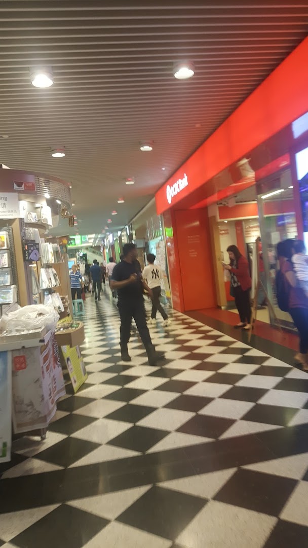 The OCBC Bank branch entrance at Jurong Point, featuring its distinctive red signage and a checkered floor.
