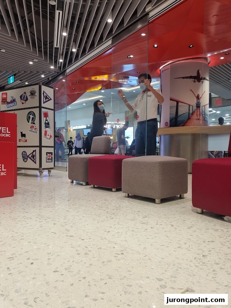 Interior view of OCBC Bank with staff and customer seating, showcasing a modern banking environment.