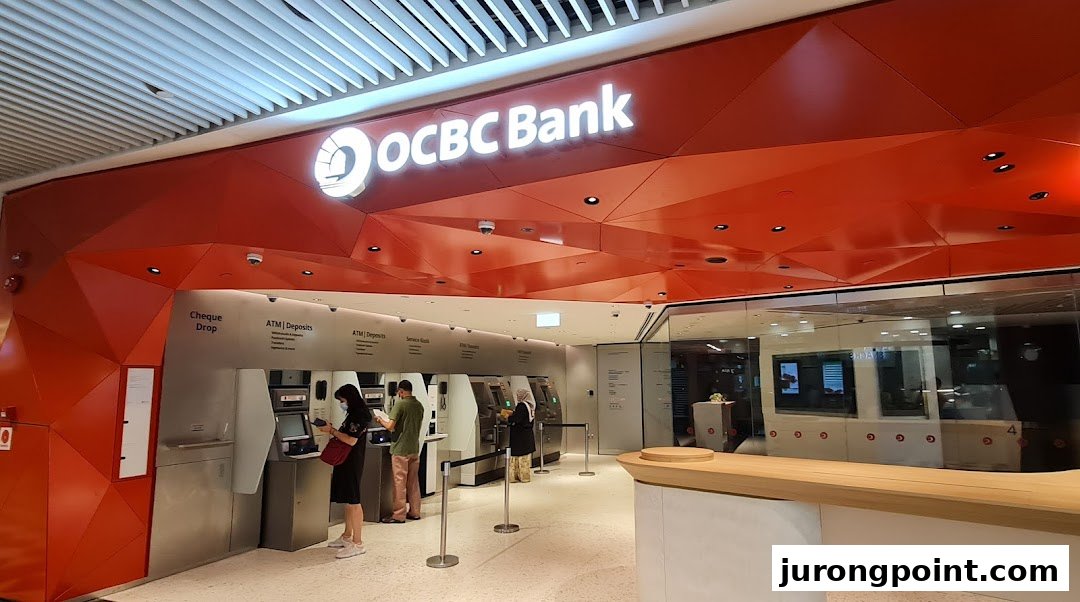 The OCBC Bank branch entrance at Jurong Point, featuring ATMs and customers using banking services.