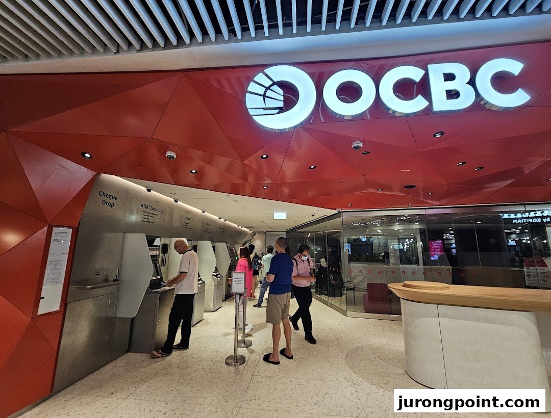 Customers use ATMs and access services at the modern OCBC Bank branch entrance.