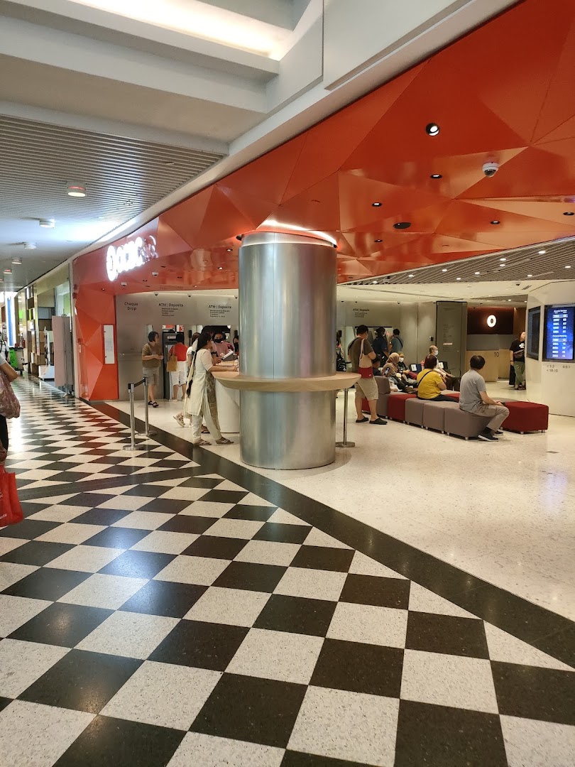The OCBC Bank branch at Jurong Point features a distinctive orange facade and a checkered floor entrance.