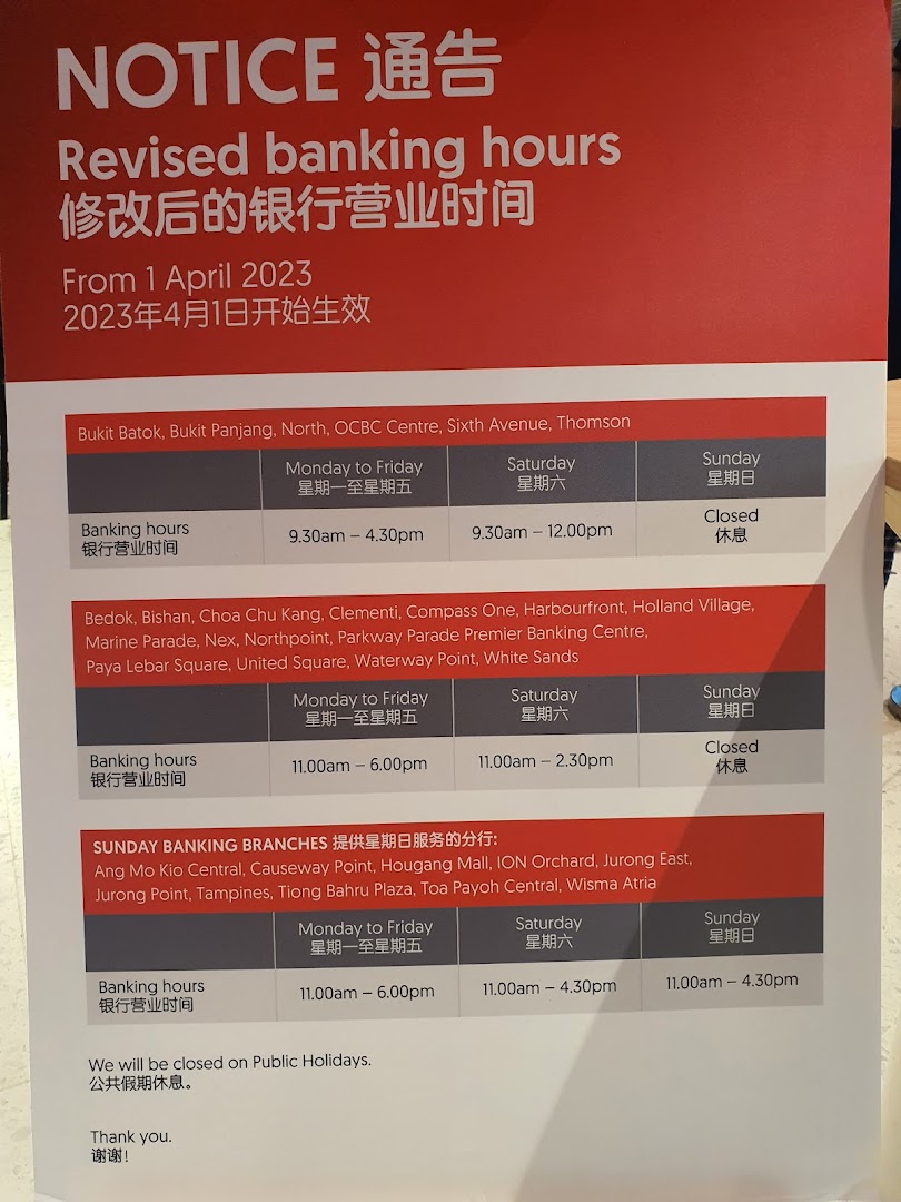 A notice displaying revised banking hours for various OCBC Bank branches, effective April 1, 2023.