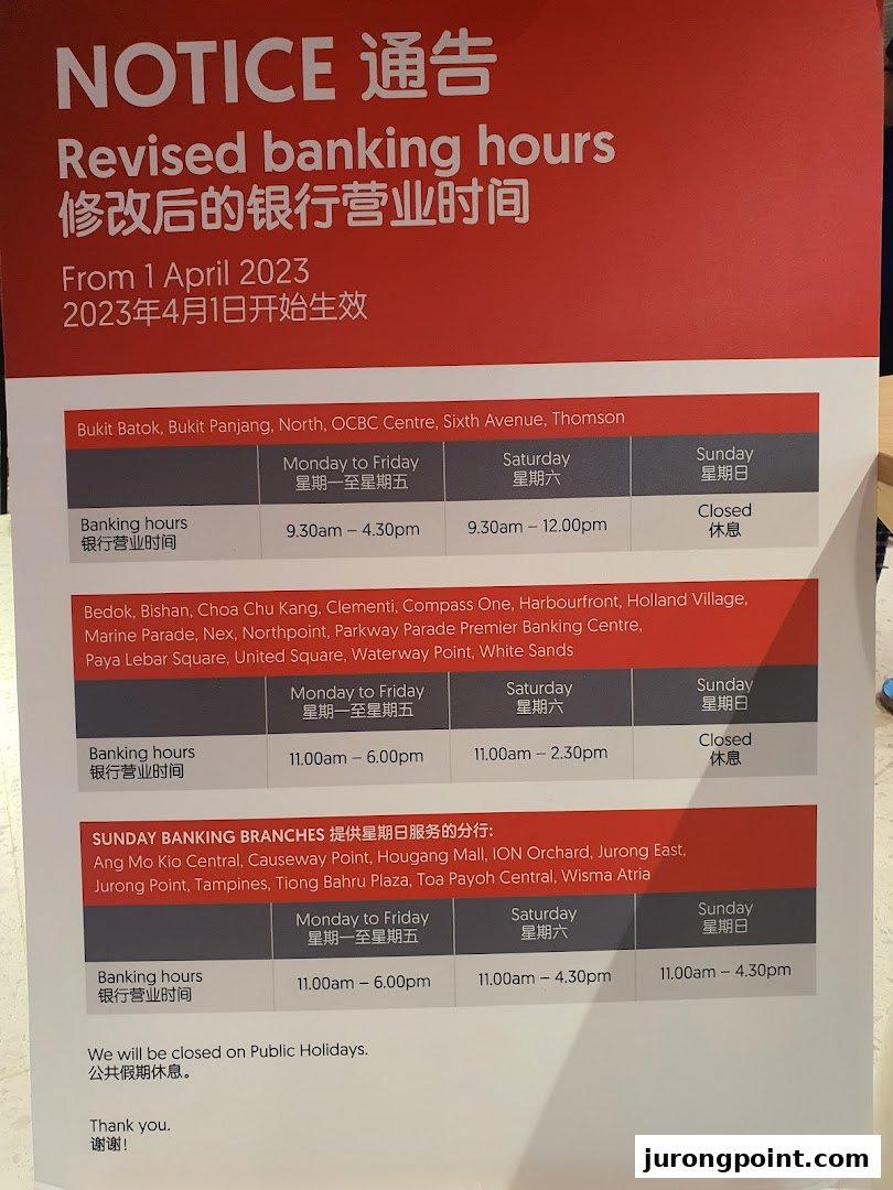 A notice displaying revised banking hours for various OCBC Bank branches, effective April 1, 2023.