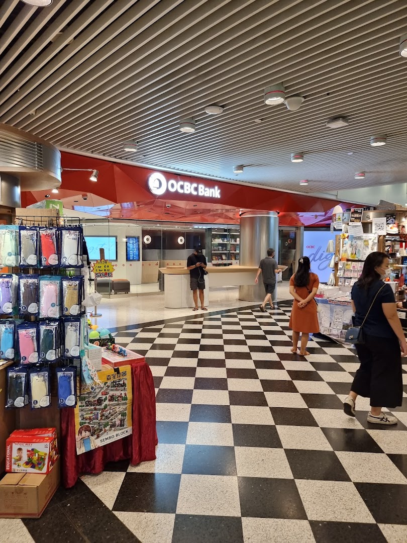 The OCBC Bank branch entrance at Jurong Point, featuring a red facade and checkered floor.