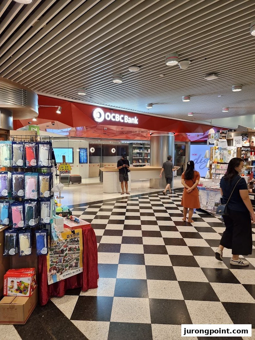 The OCBC Bank branch entrance at Jurong Point, featuring a red facade and checkered floor.