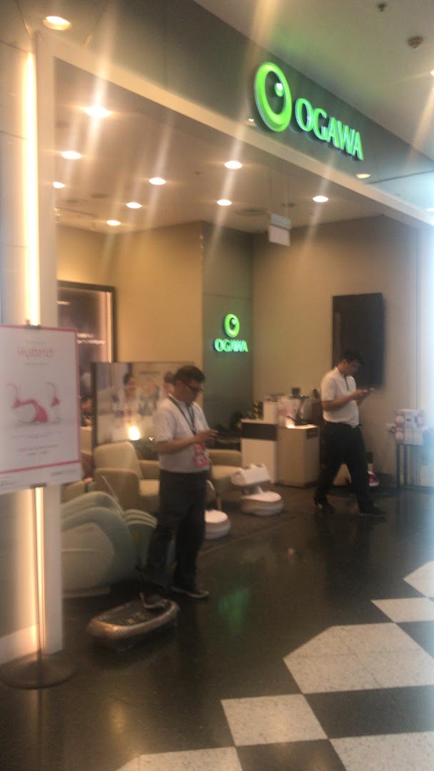 The inviting entrance of OGAWA, a wellness store, showcasing massage products and staff inside.