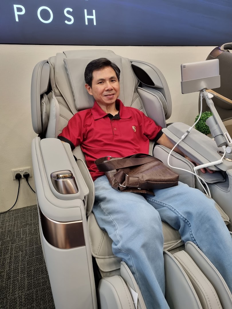 A man comfortably seated in a modern, luxurious massage chair at OGAWA.