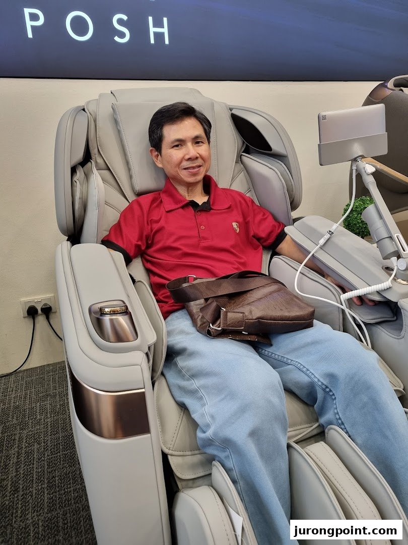 A man comfortably seated in a modern, luxurious massage chair at OGAWA.