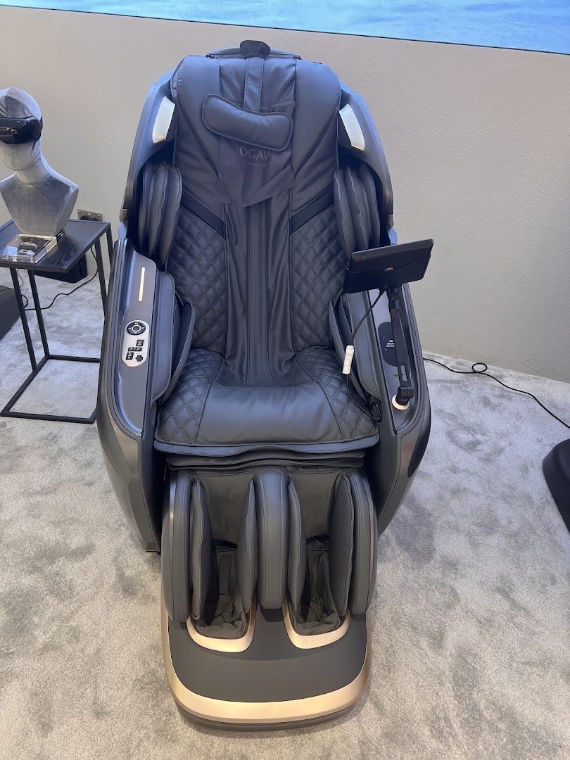 A luxurious grey Ogawa massage chair with quilted upholstery and a foot massager.