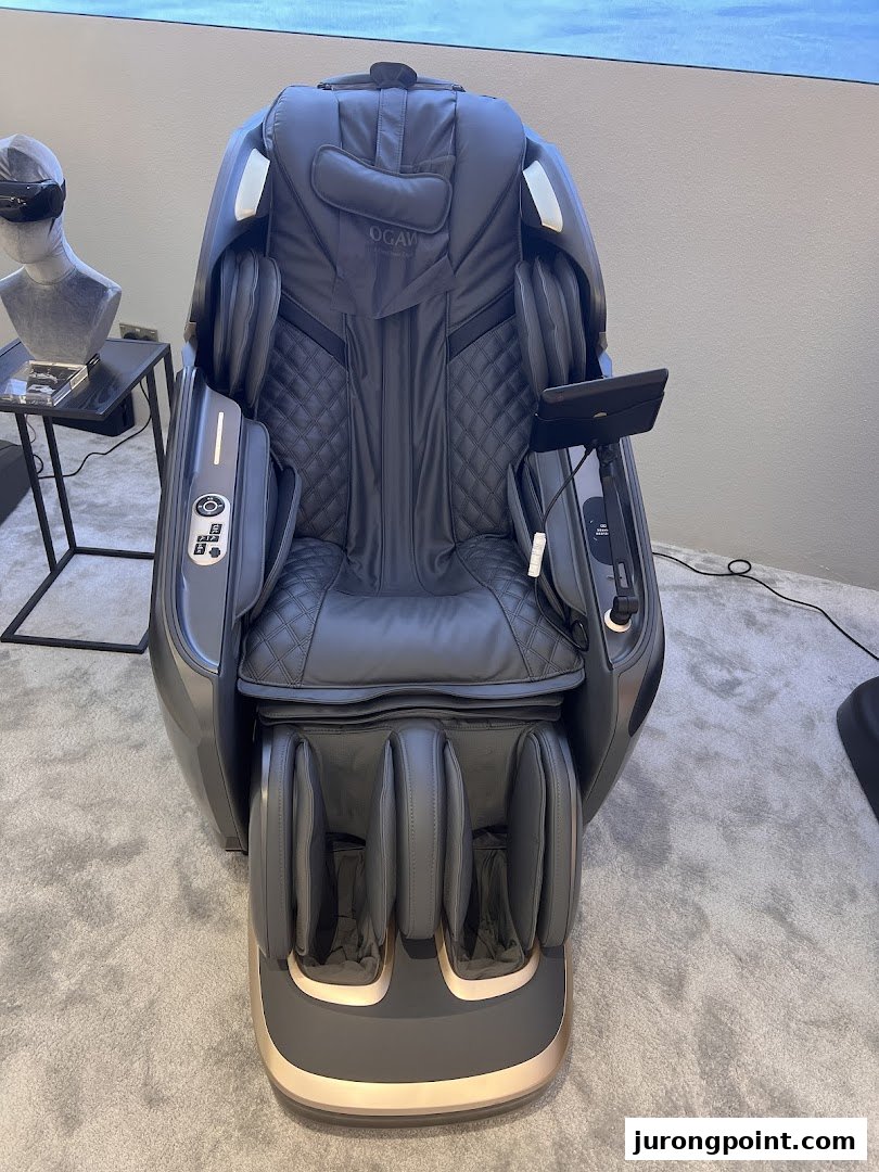 A luxurious grey Ogawa massage chair with quilted upholstery and a foot massager.