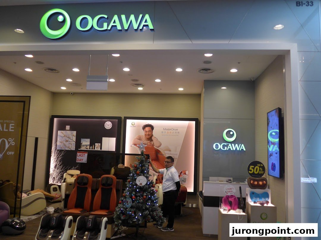 The OGAWA shop entrance showcasing massage chairs, wellness products, and festive holiday decor.