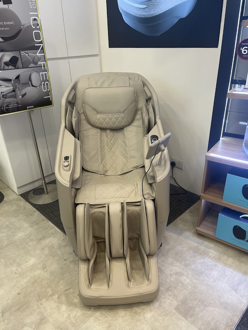 A beige OGAWA massage chair displayed prominently inside the retail store.