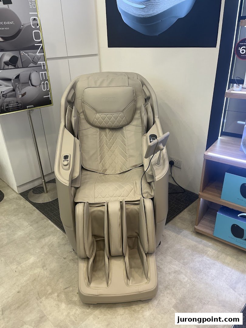 A beige OGAWA massage chair displayed prominently inside the retail store.