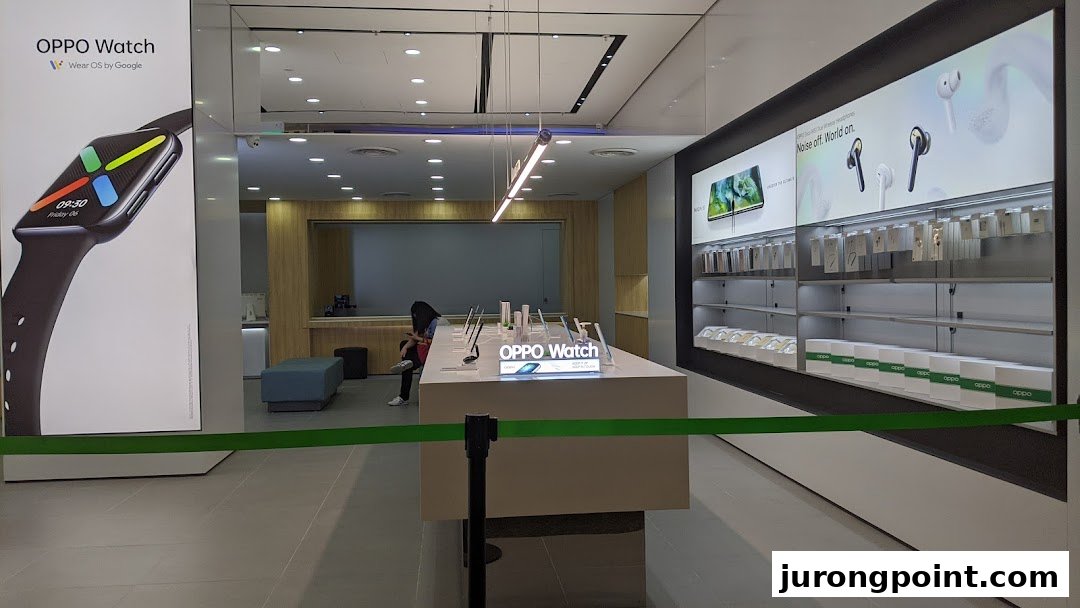 Interior view of an OPPO Concept Store showcasing smartwatches, headphones, and other tech products on display.