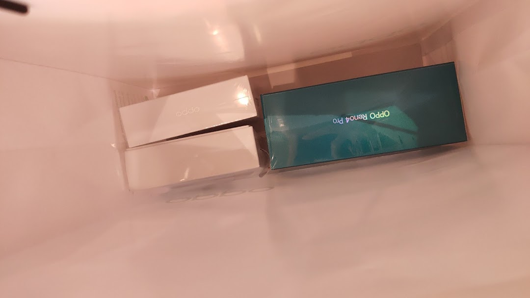 OPPO product boxes, including an OPPO Reno4 Pro, seen inside a shopping bag.