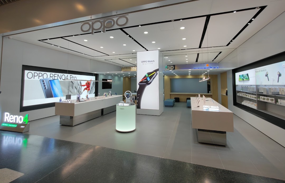Interior view of the OPPO Concept Store, showcasing smartphones, smartwatches, and accessories on modern displays.