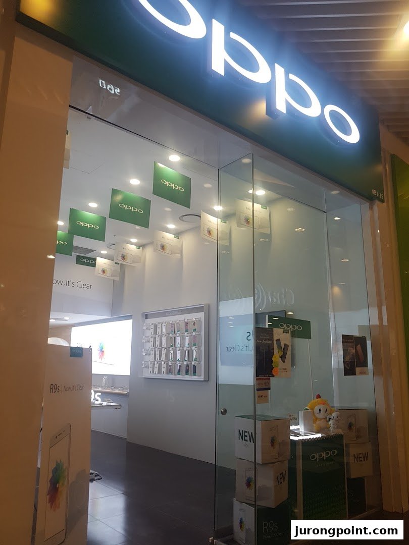 The brightly lit entrance of an OPPO Concept Store showcasing smartphones and accessories.