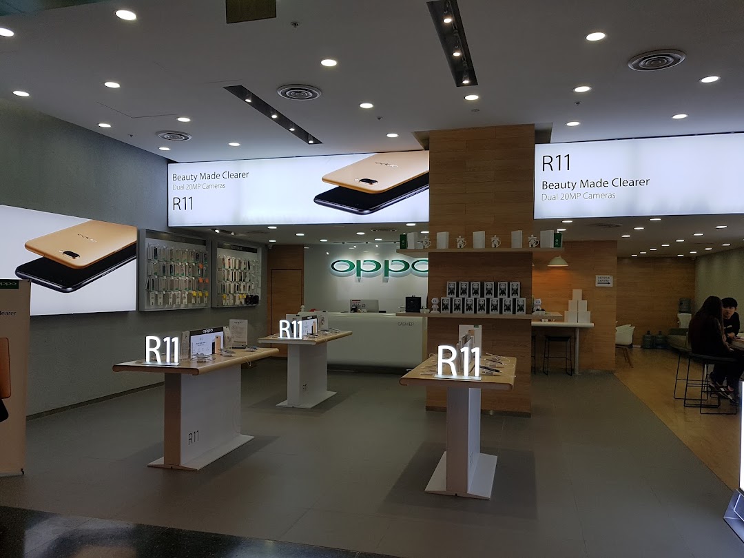 Interior view of an OPPO Concept Store showcasing R11 phones, accessories, and a service counter.
