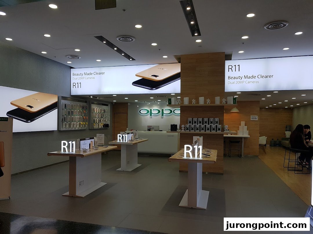 Interior view of an OPPO Concept Store showcasing R11 phones, accessories, and a service counter.