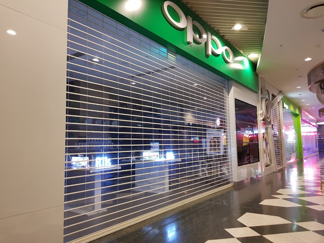 The OPPO Concept Store entrance with a closed security shutter in a shopping mall.
