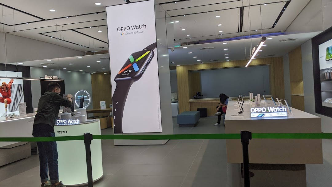 Inside the OPPO Concept Store, featuring a large OPPO Watch display and interactive product showcases.