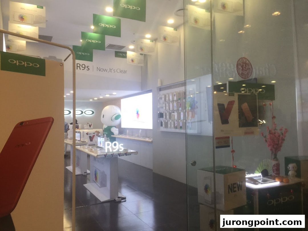 An interior view of the OPPO Concept Store showcasing smartphones and promotional displays.